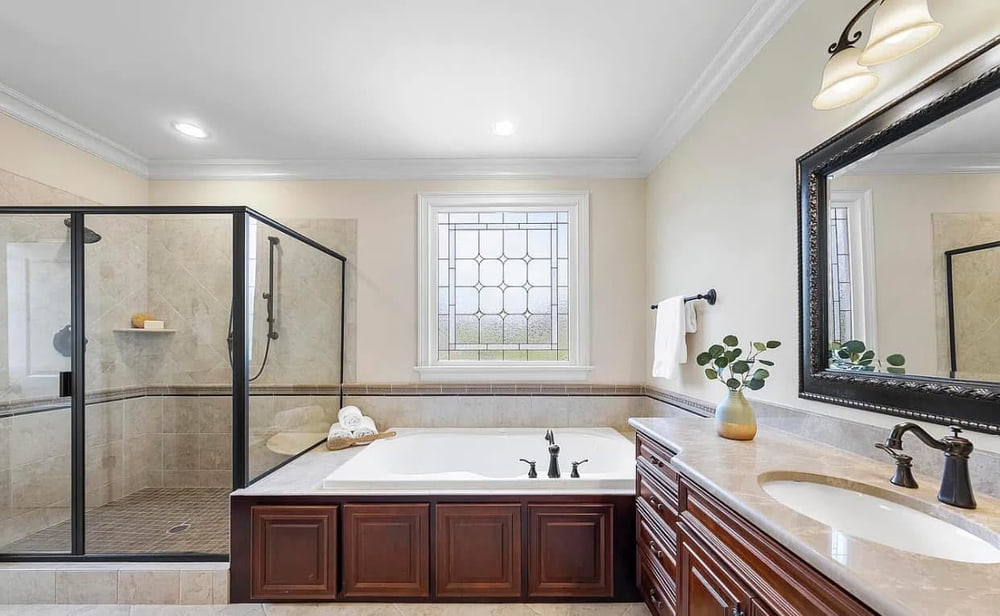 Master bathroom with corner tub, tiled shower enclosure and twin vanity